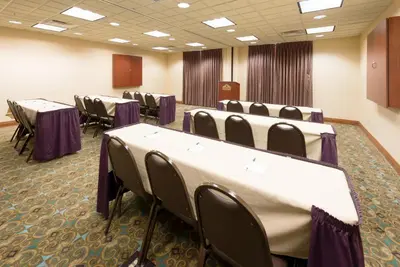 a conference room with tables and chairs in it at Wingate by Wyndham Erlanger - Florence - Cincinnati South in Erlanger