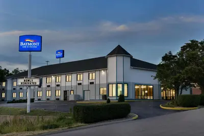 a large white building with a sign in front of it at Baymont by Wyndham Winchester in Winchester