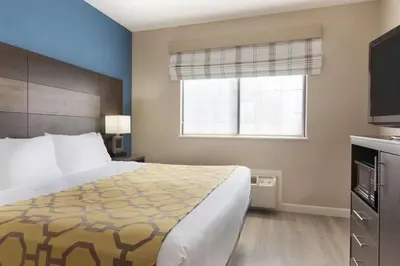 a hotel room with a bed and a window at Baymont by Wyndham Winchester in Winchester