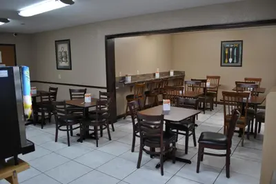 a dining room filled with tables and chairs at Quality Inn Washington Court House in Jeffersonville
