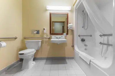 a bathroom with a toilet and a sink at Quality Inn Washington Court House in Jeffersonville