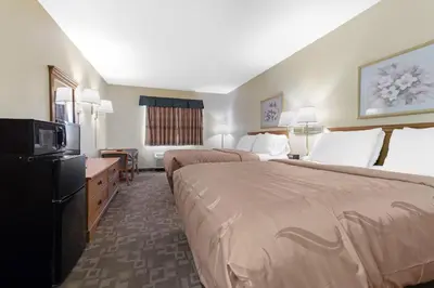 a hotel room with two beds and a television at Quality Inn Washington Court House in Jeffersonville