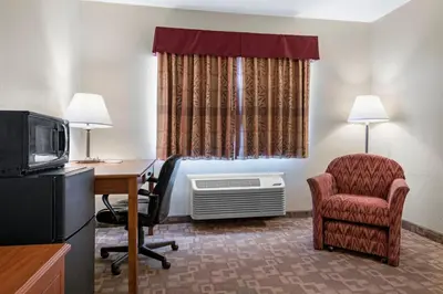 a hotel room with a desk and a chair and a tv at Quality Inn Washington Court House in Jeffersonville