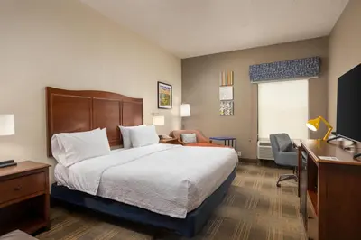 a hotel room with a bed and a desk at Hampton Inn Carrollton KY in Carrollton