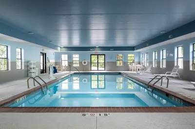 a large swimming pool in a house with blue walls at Hampton Inn Carrollton KY in Carrollton