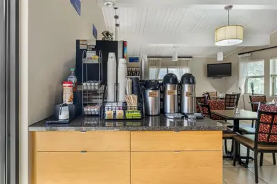 a kitchen with a counter with a coffee maker on it at Best Western Winchester Hotel in Winchester