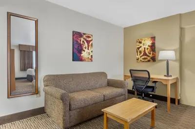 a living room with a couch and a table at Best Western Winchester Hotel in Winchester