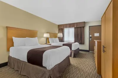 a hotel room with two beds and a bathroom at Best Western Winchester Hotel in Winchester