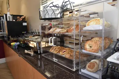 a bakery display case with many different types of bread at Best Western Winchester Hotel in Winchester