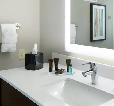 a bathroom with a sink and a mirror at Wingate by Wyndham St. Clairsville/Wheeling in Saint Clairsville