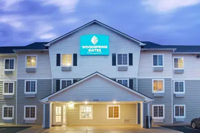 a building with a sign that reads woodworking suite at WoodSpring Suites Cincinnati Fairfield in Fairfield