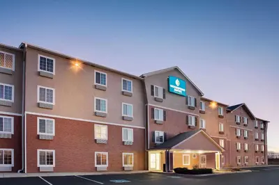 a hotel with a sign on the side of a building at WoodSpring Suites Fort Wayne in Fort Wayne