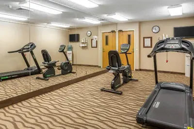 a gym with treadmills and cardio equipment in a room at Comfort Inn - Hall of Fame in Canton