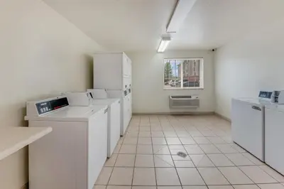 a white kitchen with white appliances and a window at Birch Hill Suites Dayton-WP AFB in Beavercreek