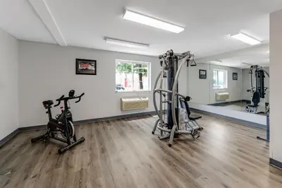 a gym with two treadmills and exercise bikes at Birch Hill Suites Dayton-WP AFB in Beavercreek
