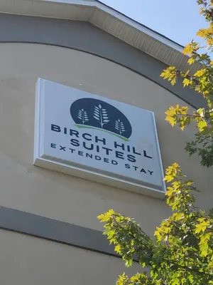a sign on the side of a building at Birch Hill Suites Dayton-WP AFB in Beavercreek