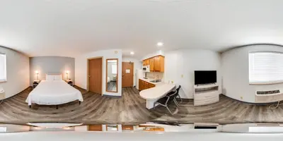a hotel room with a bed and a desk at Birch Hill Suites Dayton-WP AFB in Beavercreek