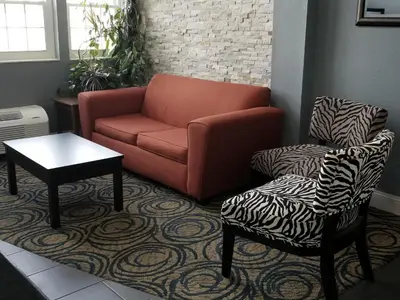 a living room with a couch and a chair at Microtel Inn & Suites by Wyndham Riverside in Dayton