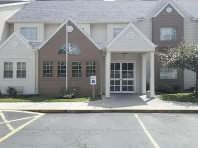 a house with a parking lot in front of it at Microtel Inn & Suites by Wyndham Riverside in Dayton