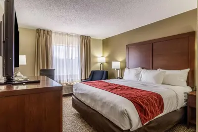 a hotel room with a large bed and a desk at Comfort Inn Norwalk - Sandusky in Norwalk