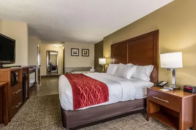 a hotel room with a large bed and a flat screen tv at Comfort Inn Norwalk - Sandusky in Norwalk