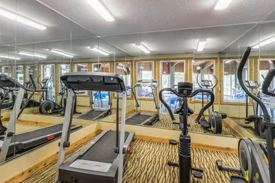 a gym with treadmills and elliptical machines at Comfort Inn Norwalk - Sandusky in Norwalk