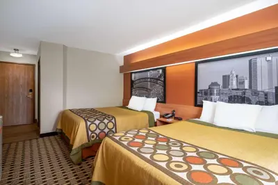 a hotel room with two beds and a large window at Super 8 by Wyndham Columbus West in Columbus