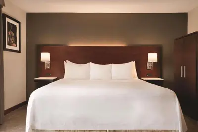 a bedroom with a large white bed with two night stands at Radisson Hotel Cincinnati Riverfront in Covington