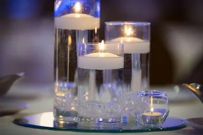 two candles in a glass vase on a table at Radisson Hotel Cincinnati Riverfront in Covington