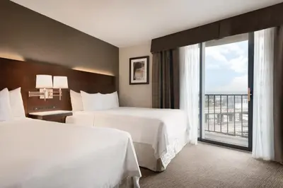 a hotel room with two beds and a large window at Radisson Hotel Cincinnati Riverfront in Covington