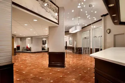 an office lobby with a reception desk and tile floor at Radisson Hotel Cincinnati Riverfront in Covington