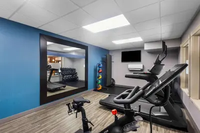 a room with a gym with exercise equipment and a mirror at Hampton Inn Marion in Marion