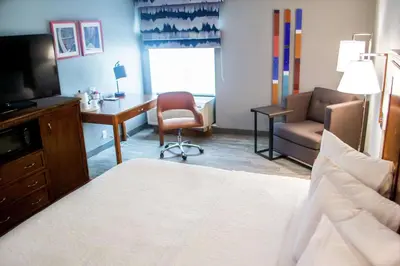 a bedroom with a bed and a desk and a chair at Hampton Inn Marion in Marion