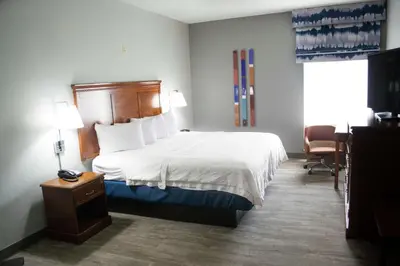 a hotel room with a bed and a desk and a chair at Hampton Inn Marion in Marion