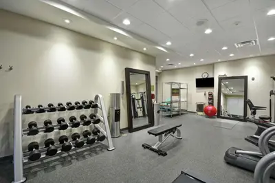 a gym with a bunch of equipment in a room at Home2 Suites by Hilton Stow Akron in Stow