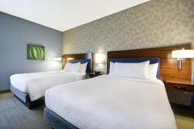 a hotel room with two beds and two lamps at Home2 Suites by Hilton Stow Akron in Stow