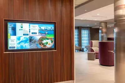 a flat screen tv on a wall in a lobby at Courtyard by Marriott Cleveland Elyria in Elyria