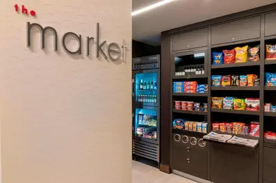a store with a market sign on a wall next to a refrigerator at Courtyard by Marriott Cleveland Elyria in Elyria