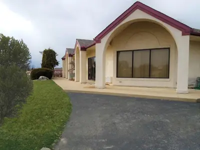 a house with a large window in a driveway at Stay Inn in Port Clinton
