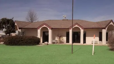 a house with a green lawn in front of it at Stay Inn in Port Clinton