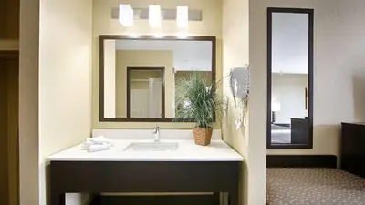 a bathroom with a sink and a mirror at Best Western Norwalk in Norwalk