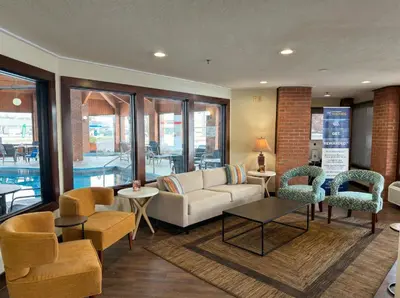 a lobby with a couch and chairs and tables at Best Western Norwalk in Norwalk