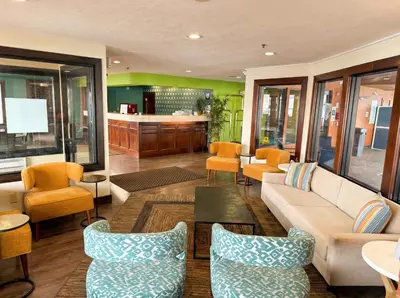 a living room with a couch and chairs at Best Western Norwalk in Norwalk