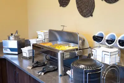 a kitchen with a grill with food in it at Berlin Encore Hotel & Suites in Berlin