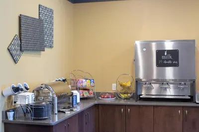 a kitchen counter with a coffee maker on top of it at Berlin Encore Hotel & Suites in Berlin