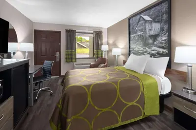 a hotel room with a bed and a desk at Super 8 by Wyndham Bridgeport/Clarksburg Area in Bridgeport