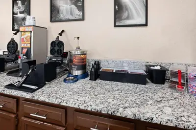a kitchen counter with a counter top with a counter top at Super 8 by Wyndham Bridgeport/Clarksburg Area in Bridgeport