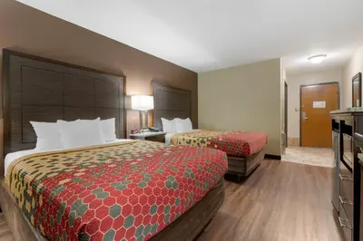 a hotel room with two beds and a bathroom at Econo Lodge Shelbyville North in Shelbyville