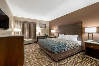 a hotel room with a bed and a desk at Econo Lodge Shelbyville North in Shelbyville