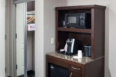 a room with a microwave and a coffee maker on a counter at Hilton Garden Inn Cincinnati/Mason in Mason